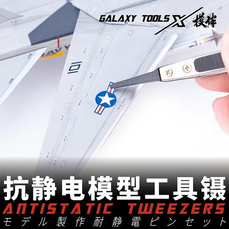 Pro-grade antistatic tweezers with replaceable chucks placing star insignia on model airplane wing
