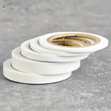 Stack of 2-10mm flexible masking tape rolls with gold core and labels