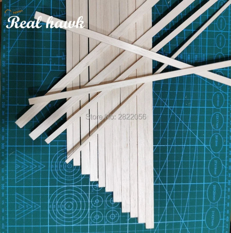 Light balsa wood strips on green cutting mat