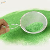 Silver sieve with long handle holding 2mm static grass powder green fluff