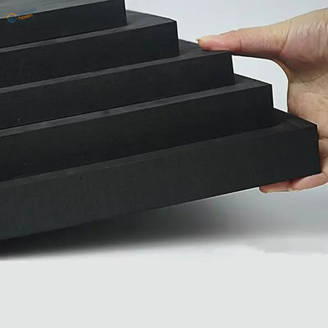Hand holding stacked high-density EVA foam sheets 5-40mm in descending sizes