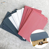 Variety of roof simulating PVC panels in red ribbed, white grid, blue textured, gray tiles