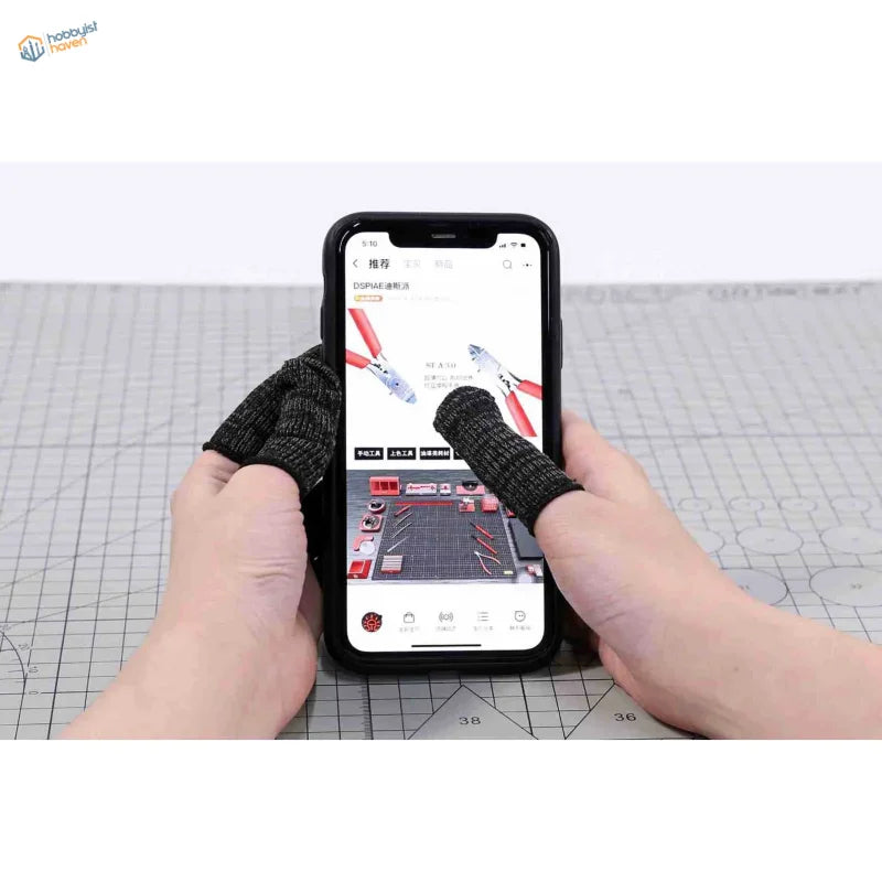 Black cut-resistant neoprene sheaths on hands holding smartphone