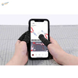 Black cut-resistant neoprene sheaths on hands holding smartphone