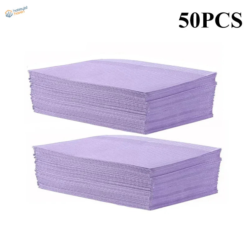 Stacks of 50 purple ribbed disposable clean pads for precision hobby tools
