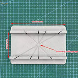White 3D-printed cutting jig gauge with diagonal slots, precision hobby tool