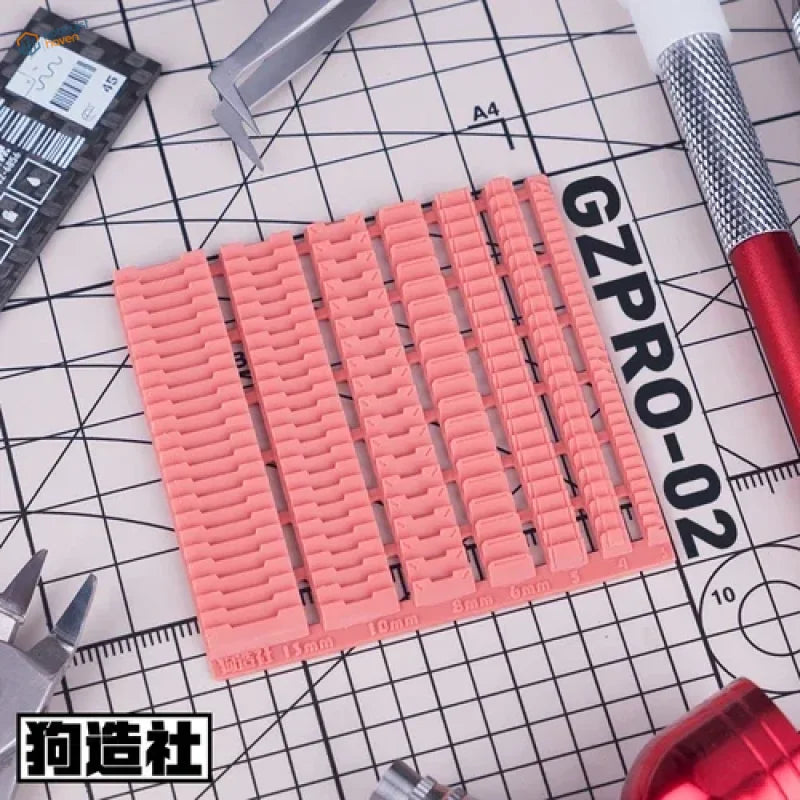 Pink 3D-printed key spacer with ribbed texture for Gundam scale modeling tools