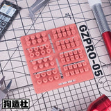 Pink 3D-printed keycap stamping tool for scale modeling Gundam parts