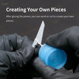 Gluing white paper knife model with blue glue on graduated plastic board