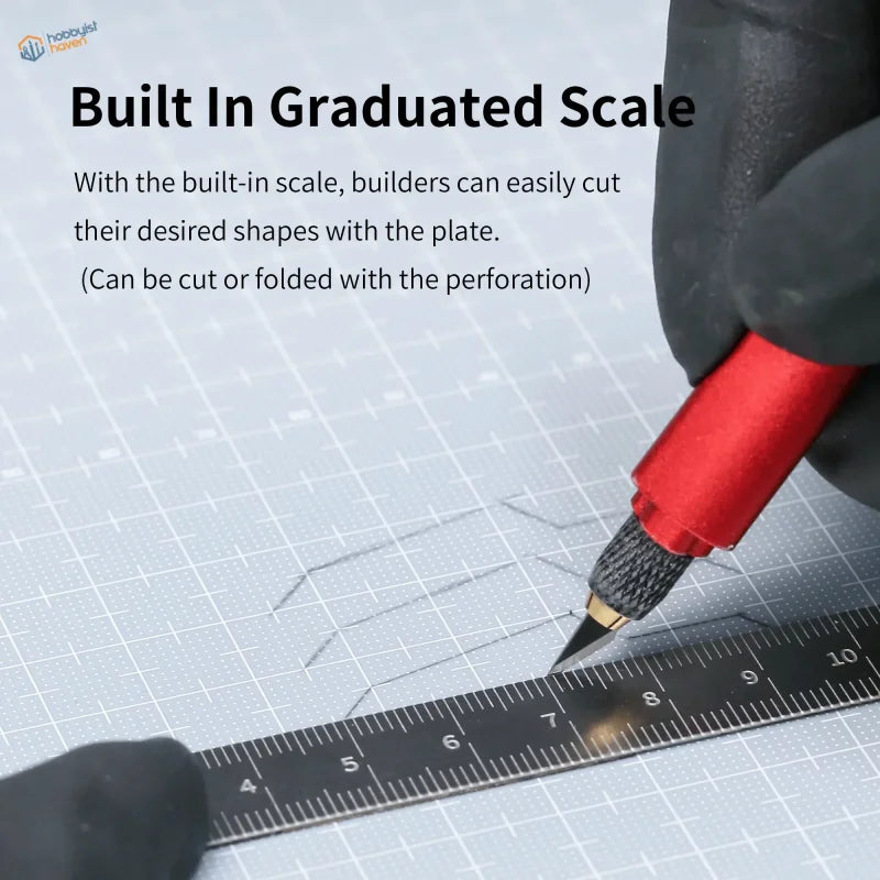 Red-handled craft knife cutting on graduated plastic board grid mat