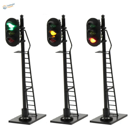 Three black ho scale railway block signals with green yellow red lights mounted on ladders for model trains