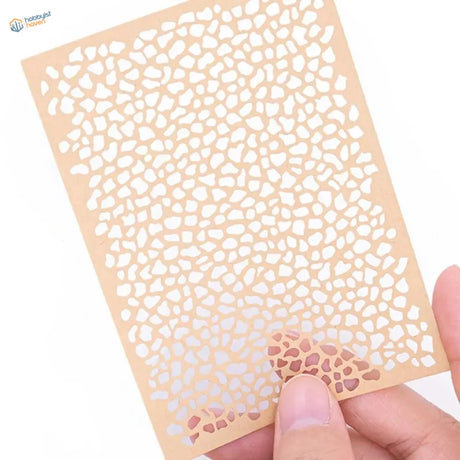 Beige craft paper marbling stencil with intricate mosaic cutouts