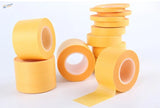 5 pieces masking tape: stacked yellow rolls with one unrolled strip