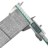 Silver digital caliper measuring gray metallic n scale stone retaining wall with textured embossed brick pattern