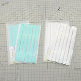 Two 50g reusable tack packs on scale modeling tools cutting mat