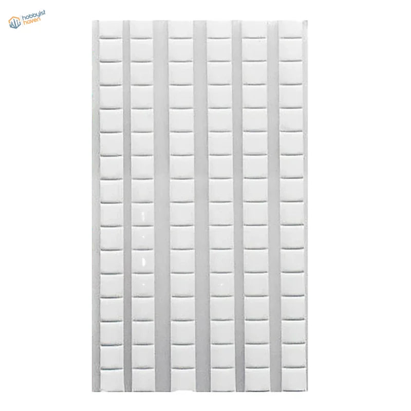 White reusable tack tile with grid indentations for scale modeling tools