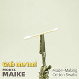 MAIKE double round tip cotton swab held by a clip against a plain background