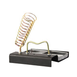 Gold soldering iron support station with black base and silver tray
