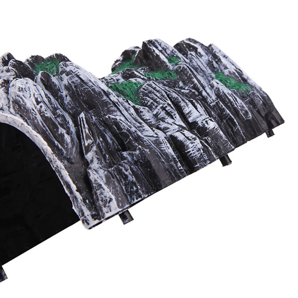 Pre-painted black and white plastic mountain rock tunnel with green accents for model railway scenery use