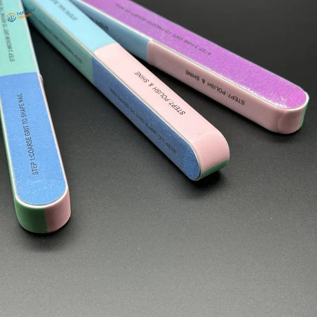 Three colorful 7-sided polishing rods with textured glittery surfaces and soft pink handles to remove mold lines