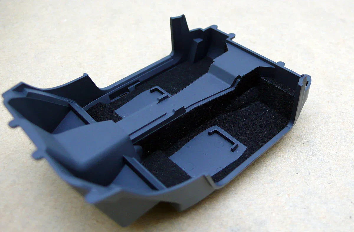 Black car interior flocking liner with molded compartments and foam padding