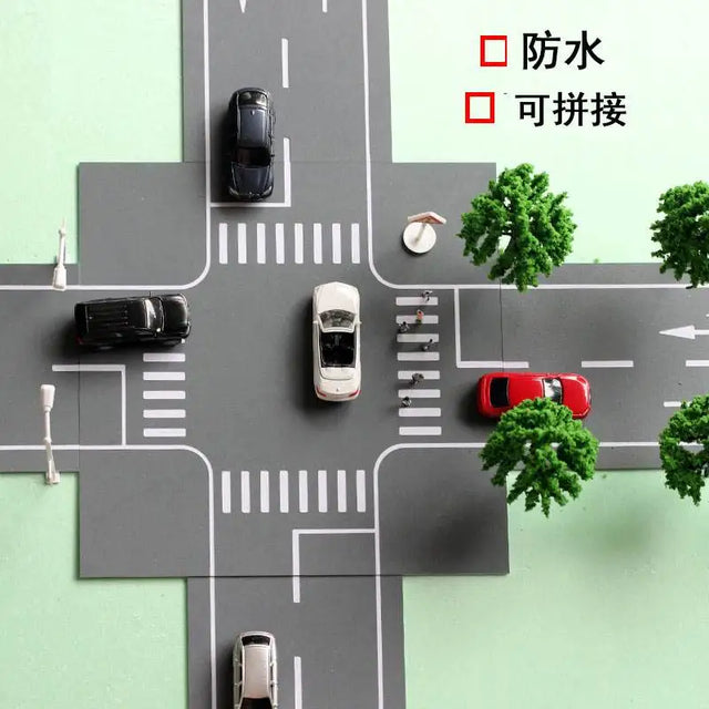 Road marking sheets forming a street junction with model cars and trees