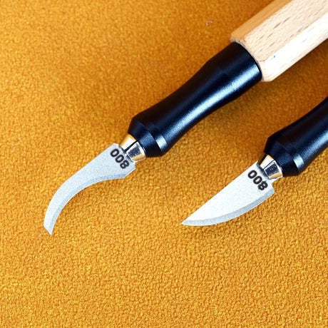 Two precision leather carving tools with black ergonomic handles and silver curved emery file blades from 100Shiki