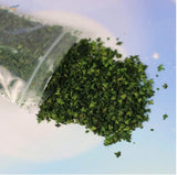 Green chopped colorful leaves spilling from 7g bag for scale modeling dioramas
