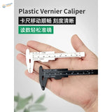 White and black 150mm plastic caliper with metric and imperial scales