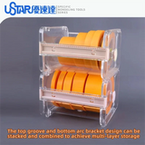 Clear plastic two-tiered ustar masking tape dispenser holding multiple rolls of bright orange masking tape