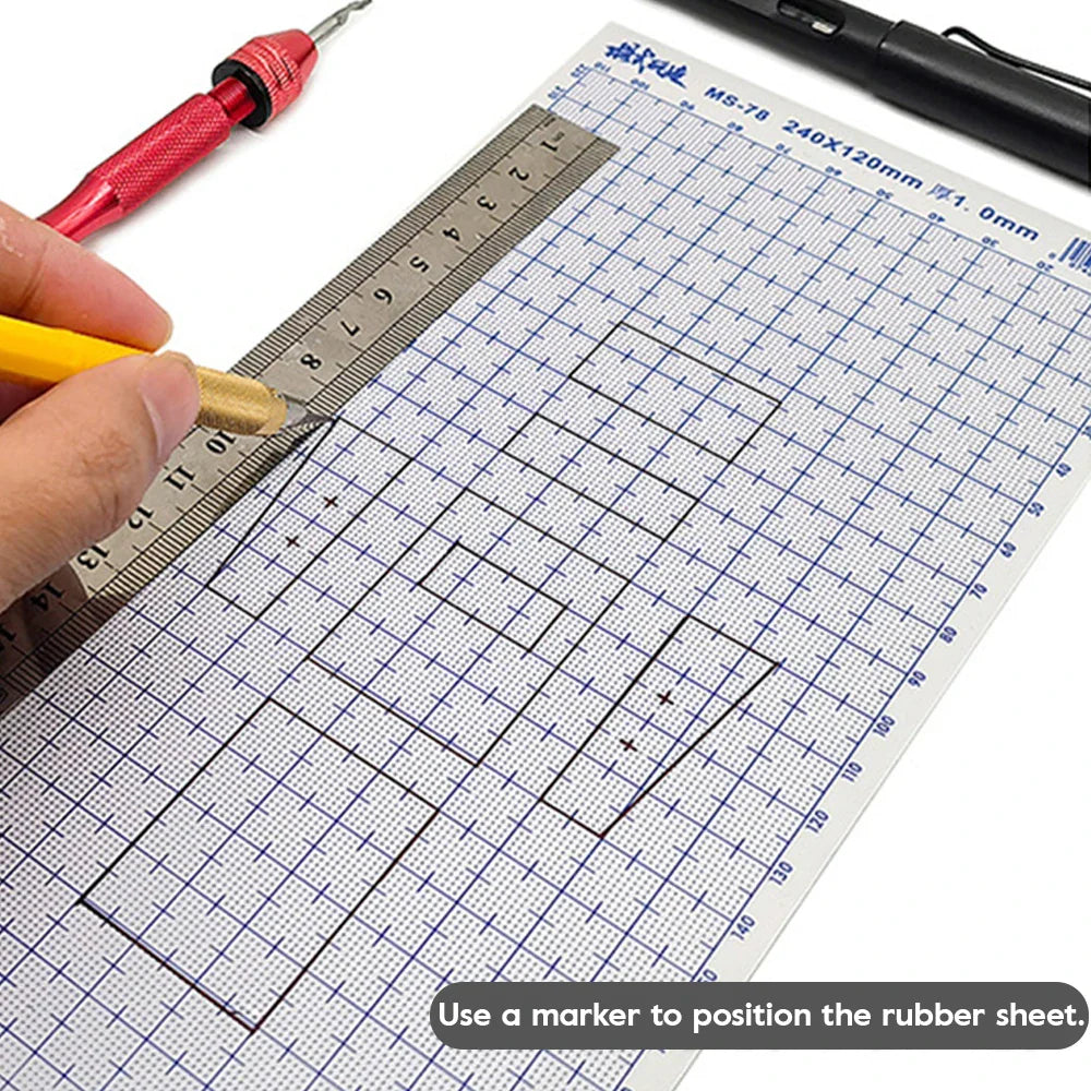 A transparent abs plastic modeling sheet with blue grid markings and a metallic ruler on a cutting mat