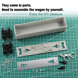 Gray plastic ho scale 1:87 high-side gondola wagon parts on green cutting mat with model building tools for assembly