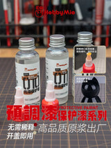 Three clear glass bottles with silver caps containing hobbymie hobby mio 50ml pre-mixed varnishes for precision hobby tools