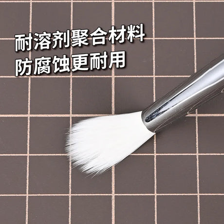 Sleek silver-handled airbrush cleaning brush with soft white bristles