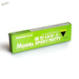 Green rectangular box of AB epoxy putty for scale modeling with black and white text label for scale modeling tools