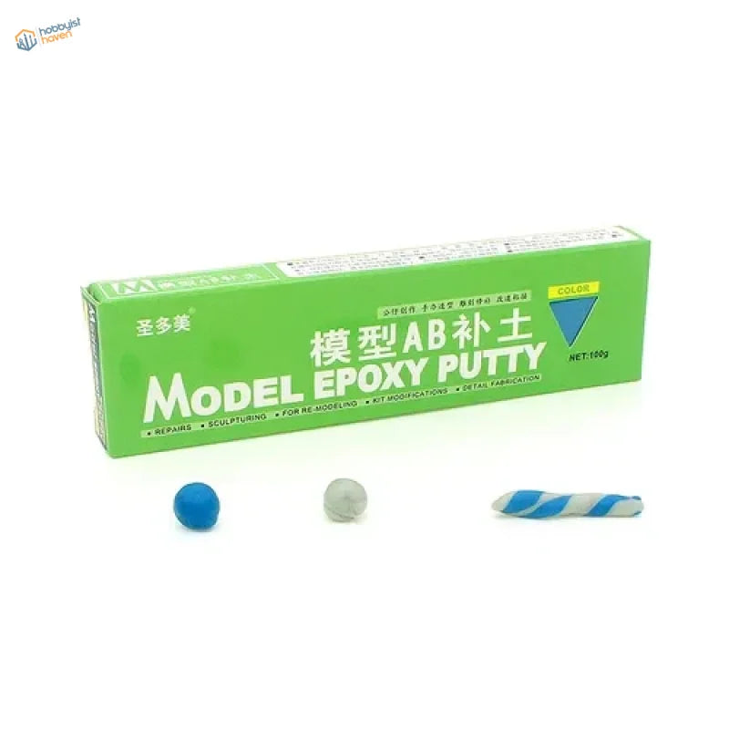 Green rectangular box of AB epoxy putty for scale modeling with samples of blue gray and striped putty in front
