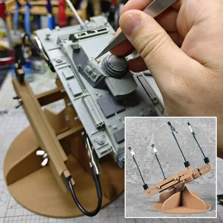 Gray plastic model tank held by metal clamps on an adjustable wooden painting stand for scale modeling tools use