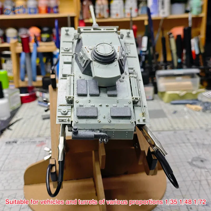 Gray plastic model tank with detailed turret on wooden adjustable model painting stand for scale modeling tools