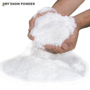 White fluffy artificial snow powder held in cupped hands
