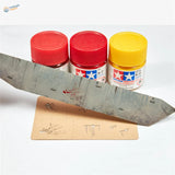 Three Tamiya paint bottles with assorted splashes effects stencil