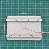 White 3D-printed cutting jig gauge with diagonal slots, precision hobby tool