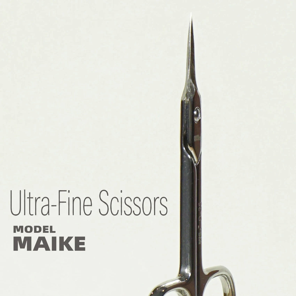 Close-up of the long needle-like tip of the MAIKE D25 scissors