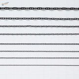 Black metal anchor chains with varying link styles arranged in parallel rows for model ships use