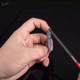 Gray plastic soldier figurine held in fingers with Border Model ultra-thin modeling file