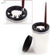 White brush cleaning bottle with black silicone lid and ring holding paintbrush