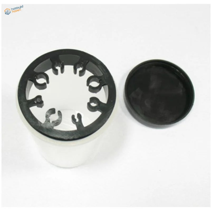 Black plastic lid with cutouts on brush cleaning bottle base
