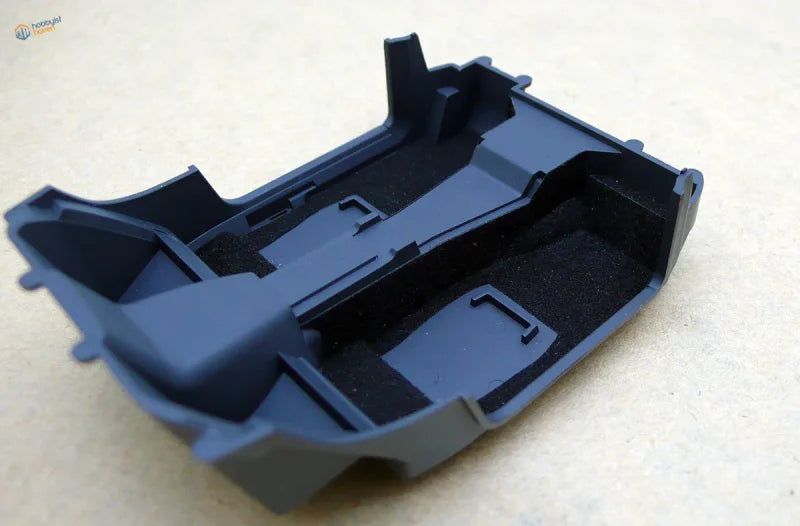 Black car interior flocking liner with molded compartments and foam padding