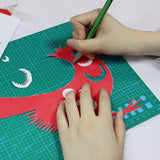 Vibrant red bird cutout shaped with colorful aluminum knife sets on green mat