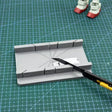 Gray 3D-printed angle ruler on precision hobby tool cutting jig