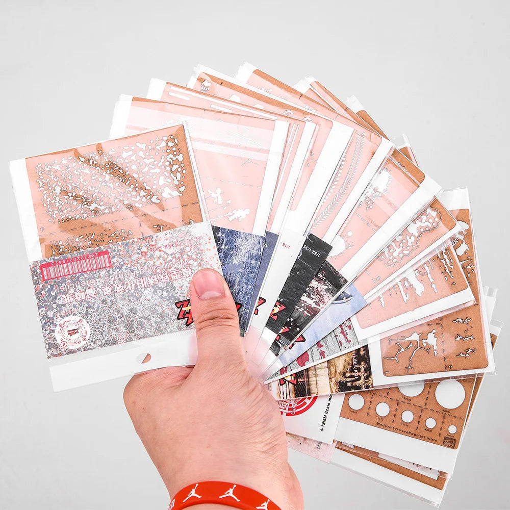 Hand holding Weathering & Effects Stencils with 12 colorful patterns